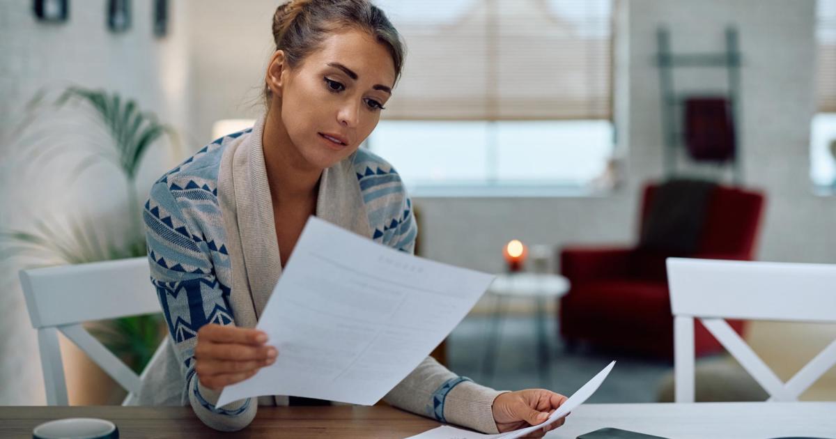 Woman looking at bill