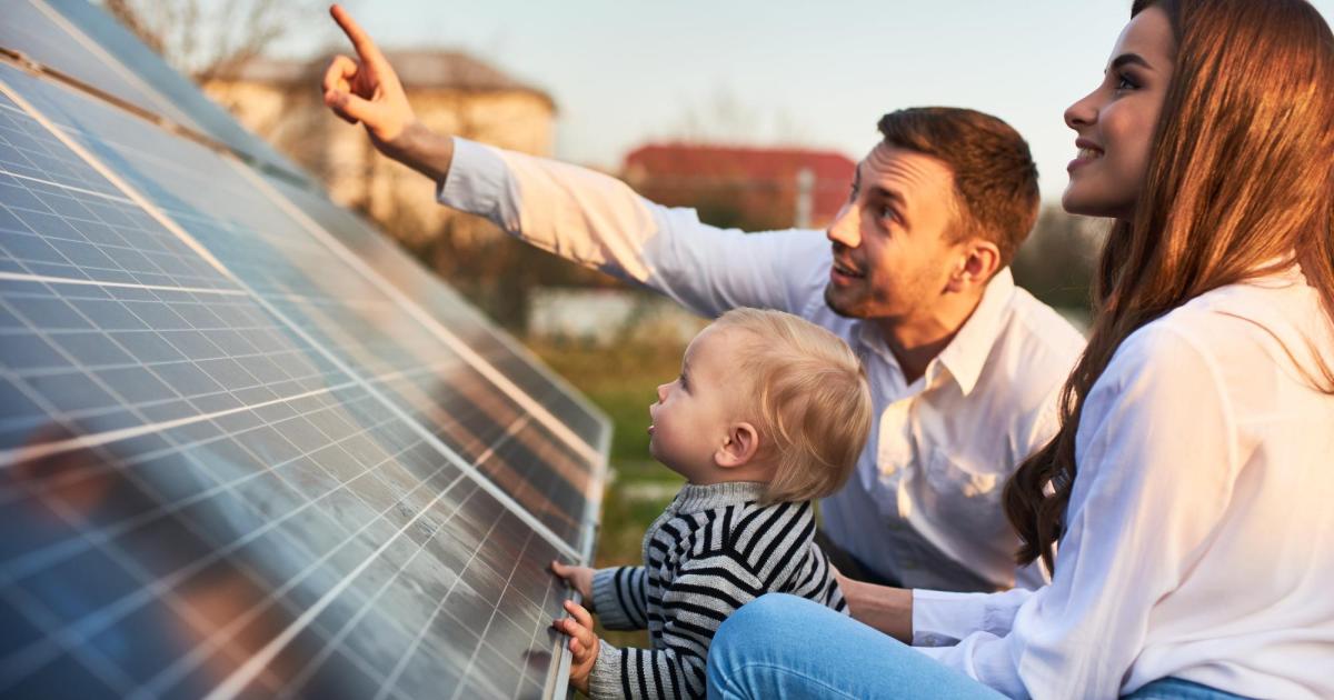 Family looking at solar panels